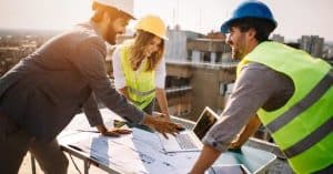 3 People Analyzing Construction Plans