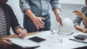 3 People working on a Construction Plan